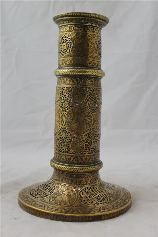 A 19th century Qajar Islamic pierced brass torch stand, 10.5in.